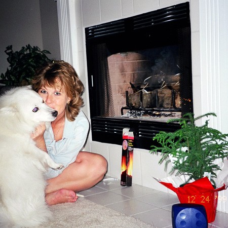 Sitting by the fire with Jersey, his favorite toy, and our Charlie Brown Christmas tree.