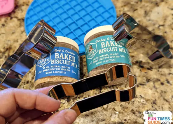 The Baked Dog Biscuit Starter Kit from Cooper's Treats comes with 2 jars of the biscuit mix (1 Turkey & Cinnamon flavor, and 1 Beef & Cheddar flavor), plus 3 bone-shaped cookie cutters in different sizes.