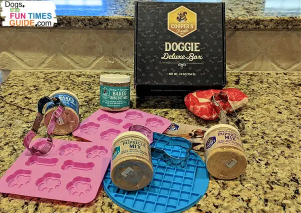 The Doggie Deluxe Kit from Cooper's Treats includes 2 jars of baked biscuit mix, 2 jars of Pupsicle mix, 2 bone- and paw-shaped silicone molds, 1 silicone lick mat, 3 bone-shaped cookie cutters, and 1 squeaky dog toy. Here's my review of Cooper's dog treat mixes.