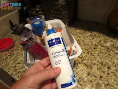 Here I'm getting the Corium 20 dog ear cleaner out of our dog's first aid kit - kept in a kitchen cabinet.
