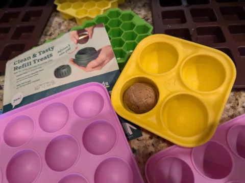 This photo shows how close in size the WOOF Pupsicle silicone trays are to original Pupsicle refill treats. photo by Lynnette at TheFunTimesGuide.com This photo shows how close in size the WOOF Pupsicle silicone trays are to original Pupsicle refill treats.