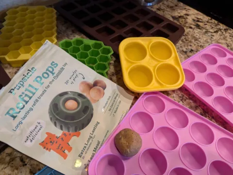 This photo shows how close in size the original Pupsicle refills are to the pink silicone molds I bought. photo by Lynnette at TheFunTimesGuide.com This photo shows how close in size the original Pupsicle refills are to the pink silicone molds I bought.