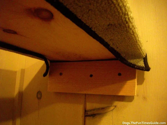 A closeup of the piece of wood that attached to the wall and held the dog ramp in place. 