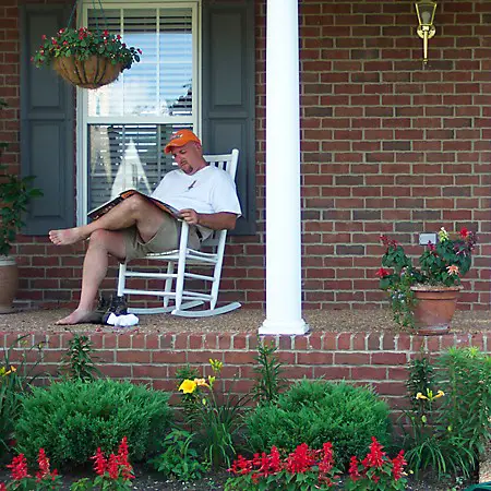 Jim reading the paper on the front porch.