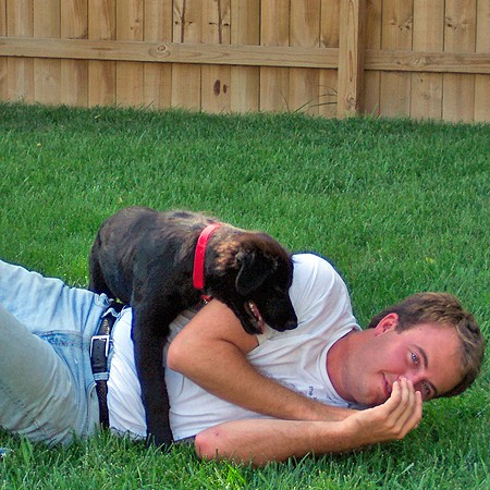 Destin using Mike as a trampoline in the backyard.