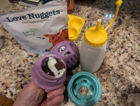 Here, I filled a Pupsicle with a few of the WOOF "love nuggets" and some plain Greek yogurt that I keep in a squeezable mustard bottle. photo by Lynnette at TheFunTimesGuide.com Here, I filled a Pupsicle with a few of the WOOF "love nuggets" and some plain Greek yogurt that I keep in a squeezable mustard bottle.